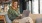 a woman sitting with a laptop near windows