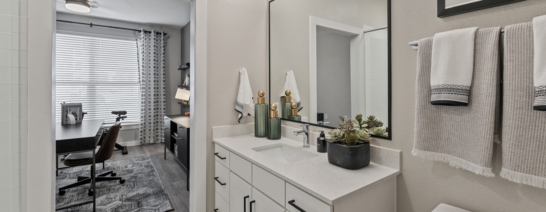 a bathroom with a large vanity and mirror